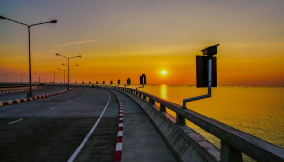 Curved,Coastal,Road,With,Street,Lamp,And,Orange,Sky,At
